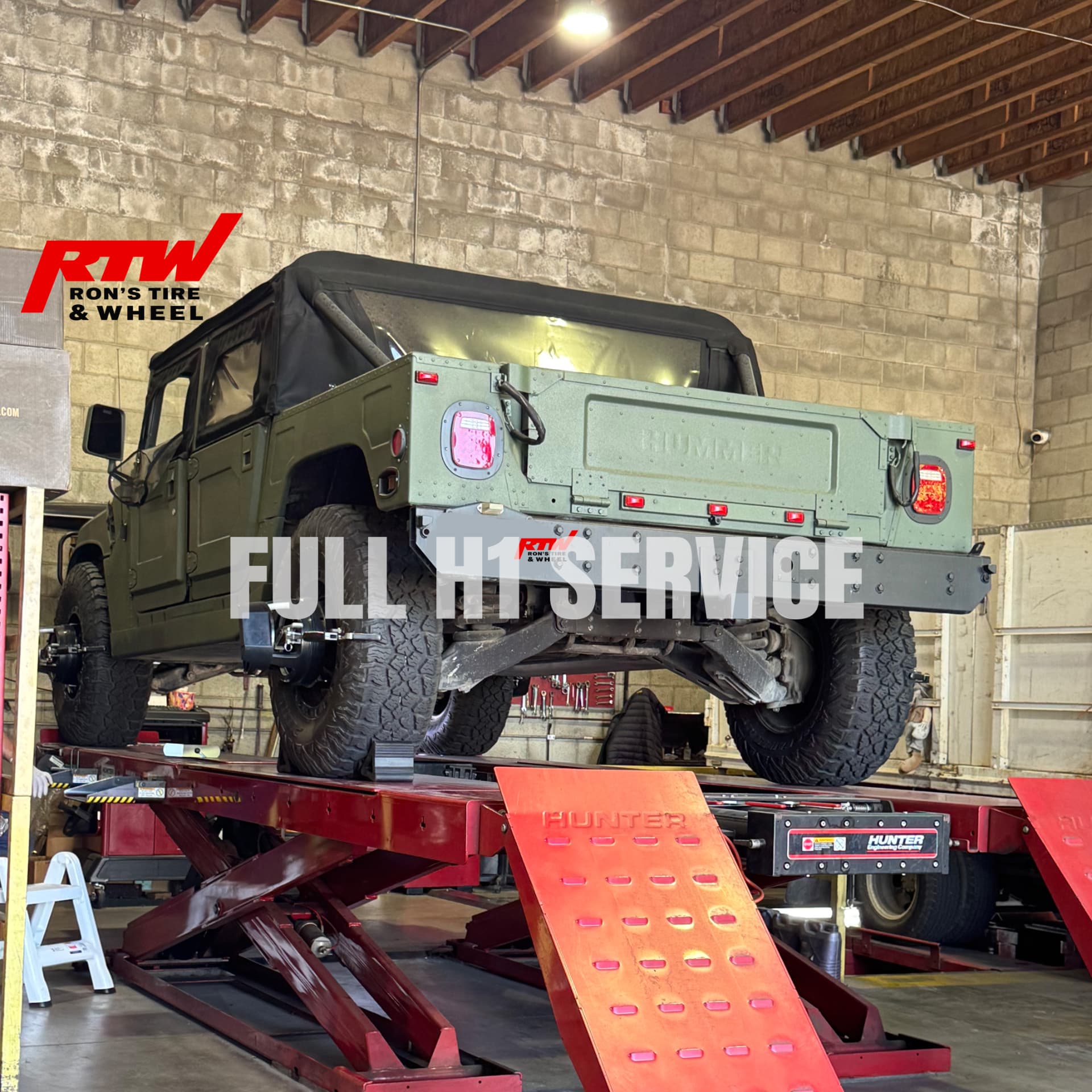 Hummer H1 raised on a Hunter alignment lift at Ron's Tire & Wheel in North Hollywood